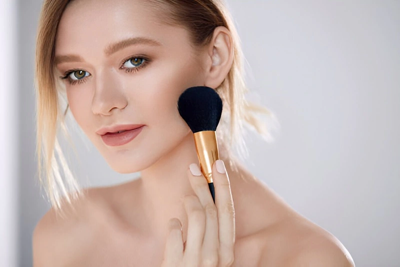  Woman With Natural Makeup Applying Powder